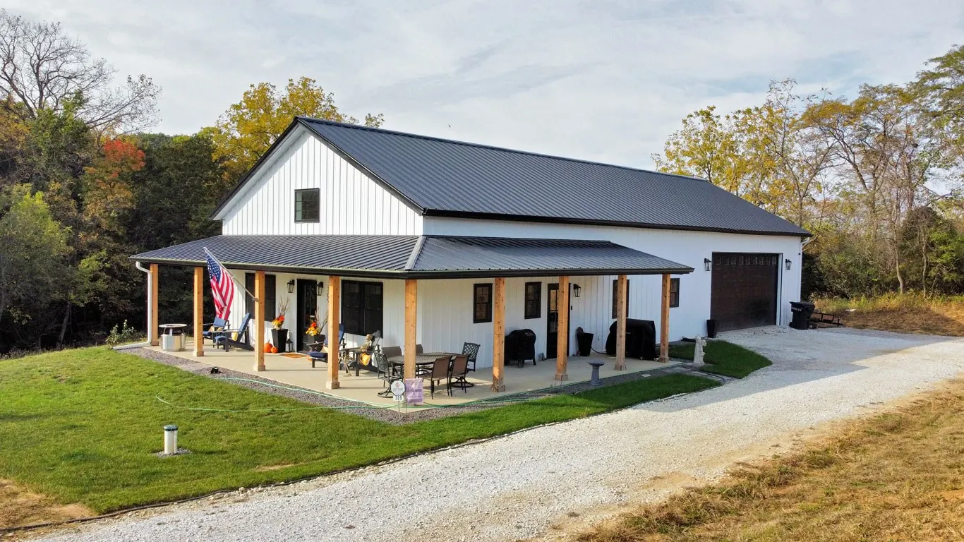 White barndominium with a full-length covered porch