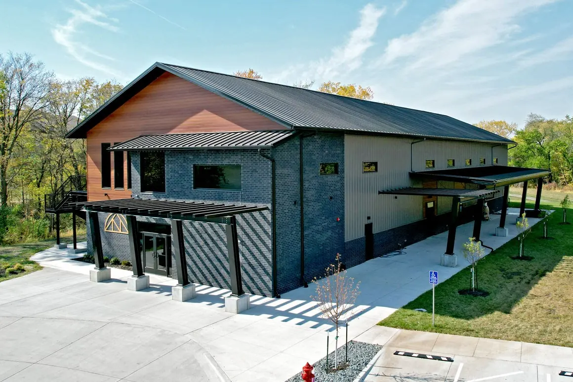 Commercial post-frame building with glazing and a covered entry