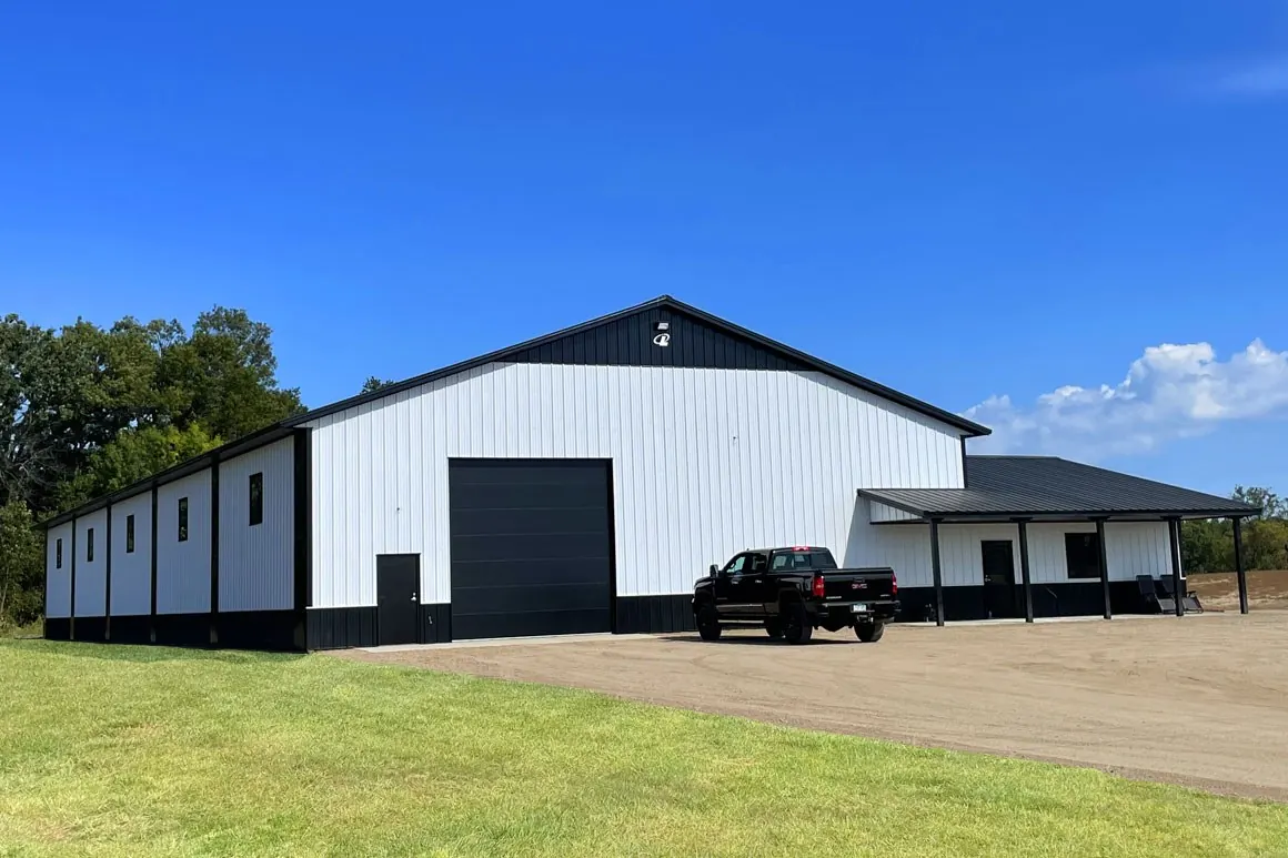Contractor shop with a tall drive-through door and fleet parking