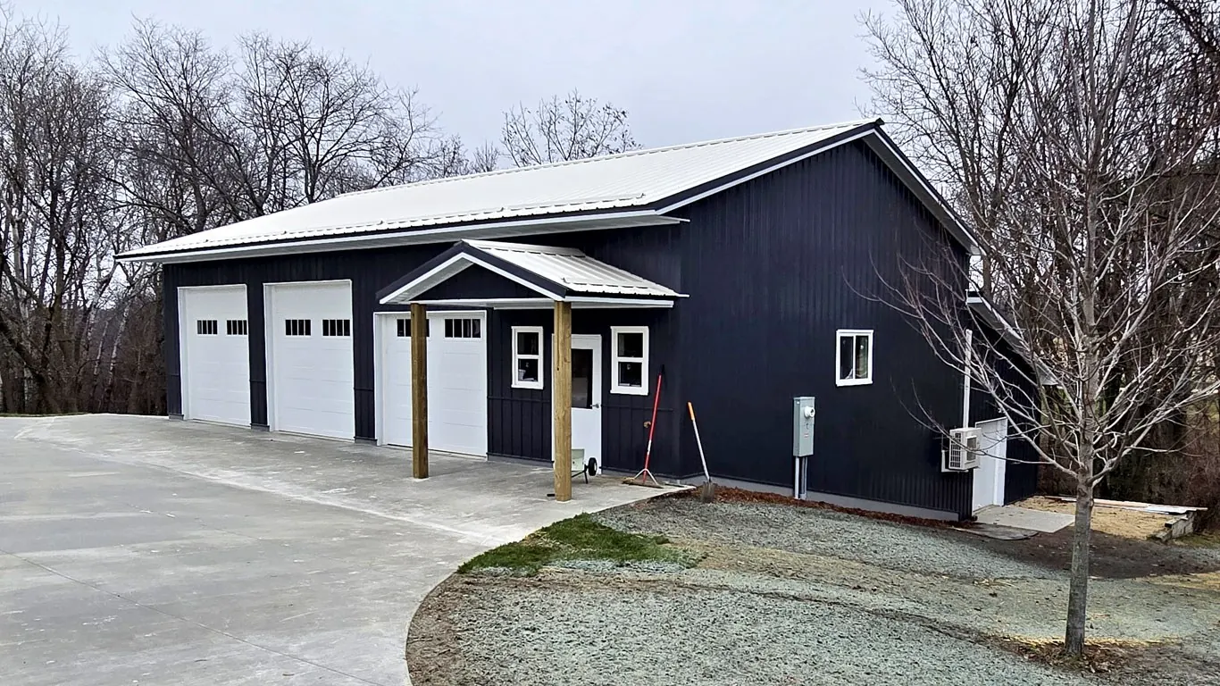 Post-frame shop with charcoal steel and three overhead doors