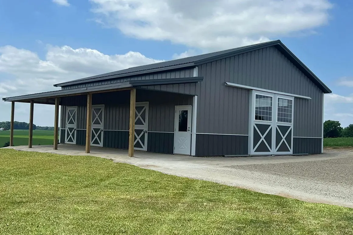 Horse barn with a covered overhang and cross-buck doors